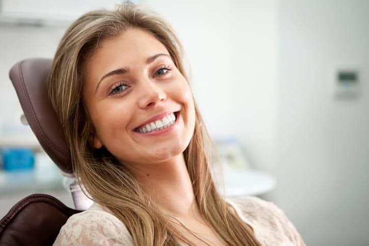 A woman smiling at the dentist's office.