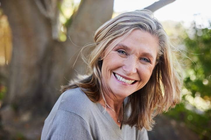 An older woman smiling for the camera.