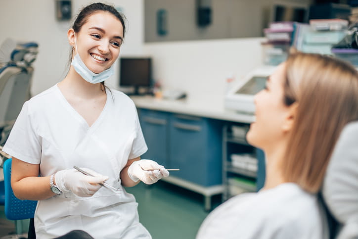 A general dentist speaking with a patient.